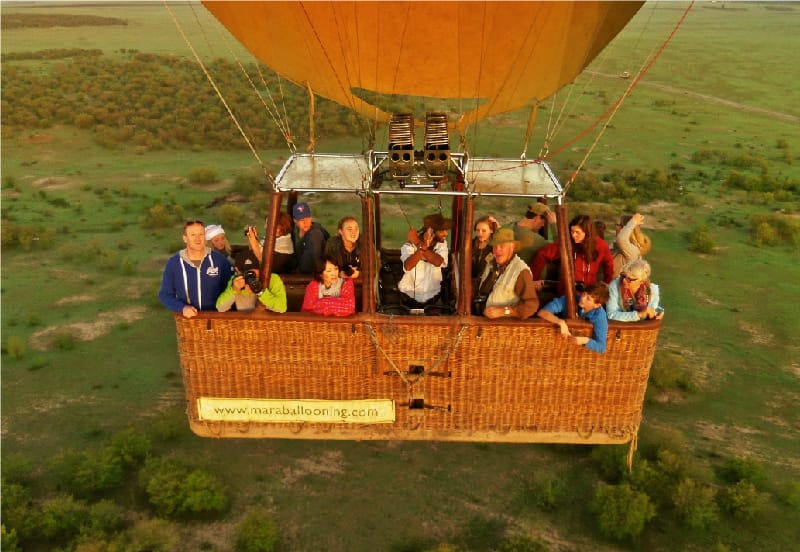 High angle view of people in hot air balloon against landscape